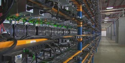 Vast rows of mining rigs in a large mining farm